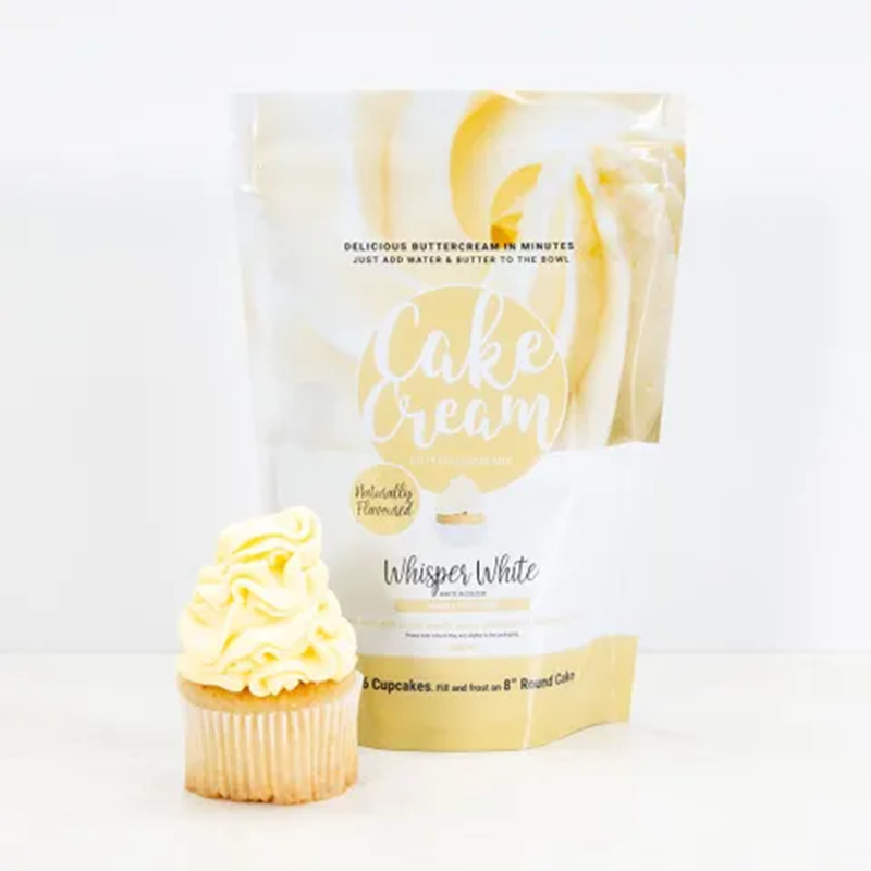 Bag of 'Cake Cream' Whisper white buttercream frosting with a frosted cupcake on a white background