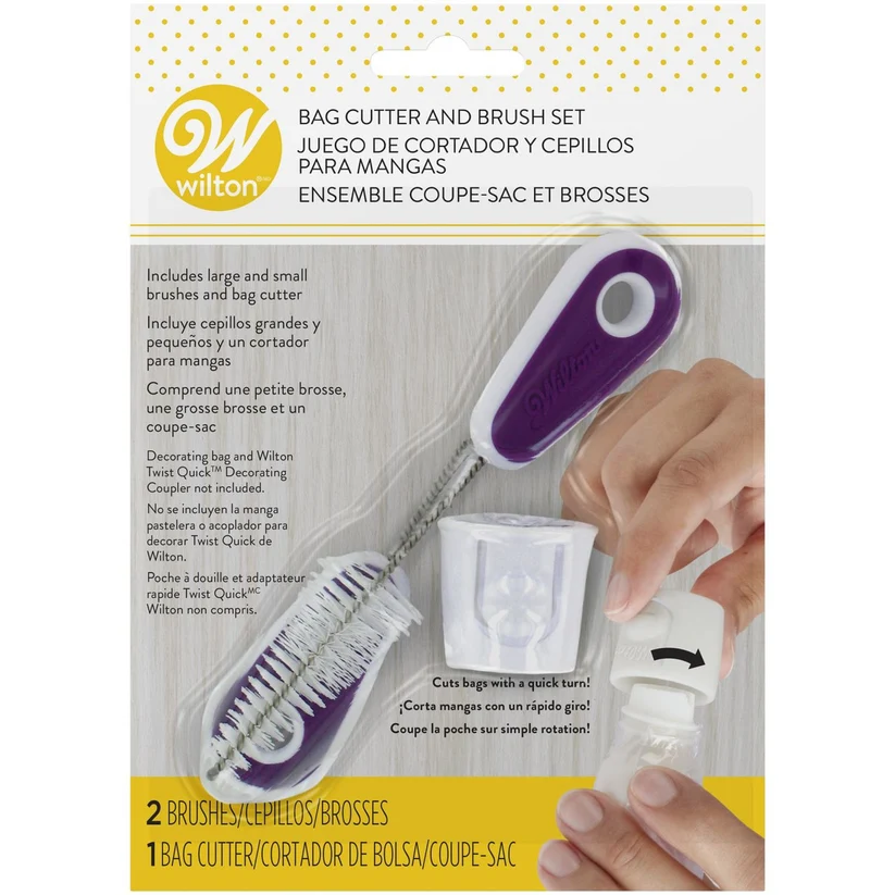 Wilton bag cutter and brush set in retail packaging, showing the purple and white bag cutter being used with two brushes and accessories. The package includes English and Spanish text and a Wilton logo.