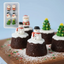Mini chocolate cakes decorated with snowmen and Christmas trees on a wooden board.