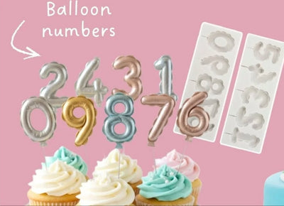 Balloon numbers (made from Edible Modelling paste and painted with edible paint) in various colors with their corresponding silicone mould on a pink background.