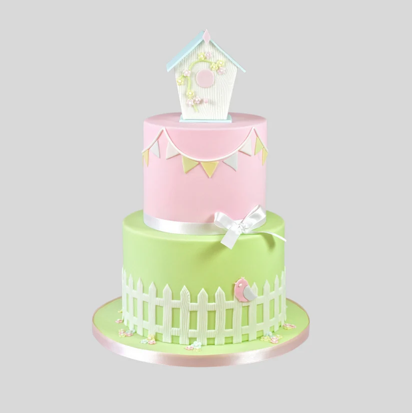 a cake with a small birdhouse on top