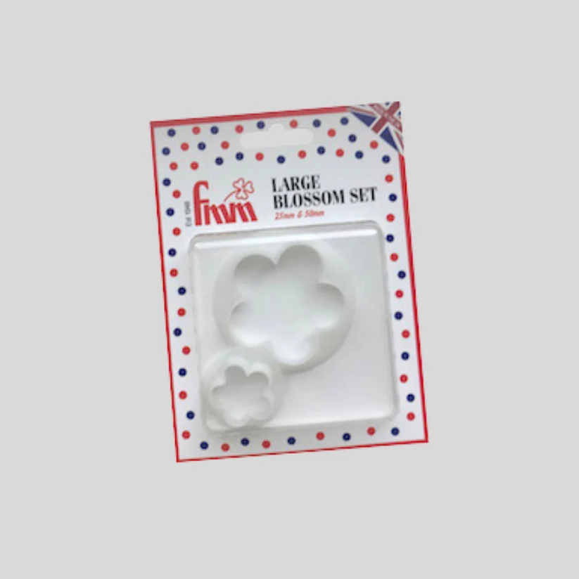 A craft set of two white plastic flower-shapedcutters in a blister pack with a patriotic red, white, and blue polka dot border. The packaging text reads 'LARGE BLOSSOM SET' and shows the brand 'FMM'.