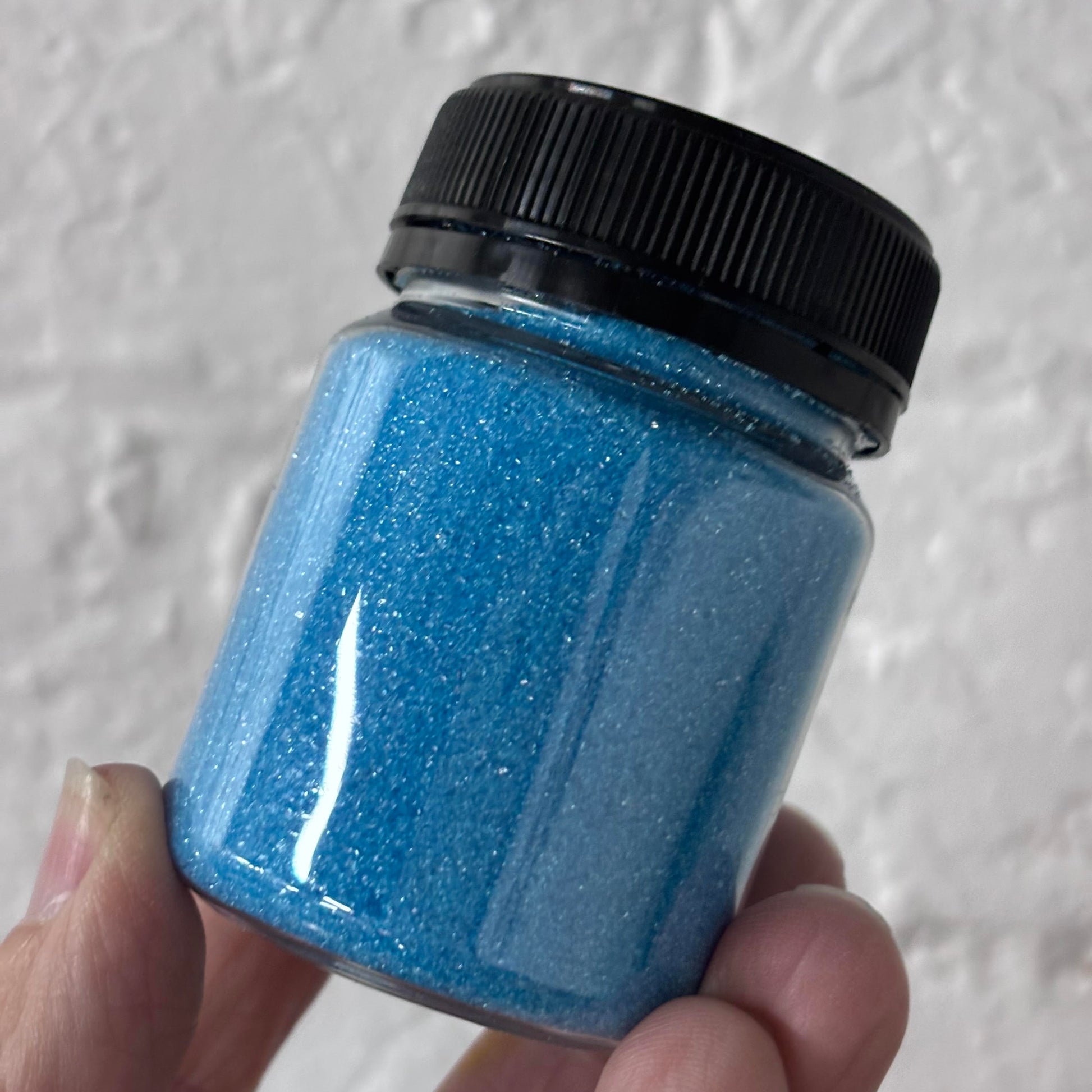 Fine blue sanding sugar sprinkles in jar