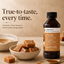 A bottle of Lorann Better Than Extracts Brown Butter flavoring stands on a beige surface beside bowls of caramel-colored candy or sauce, with promotional text reading 'True-to-taste, every time.'.