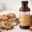 Lorann Brown Butter extract bottle with cookies and loaf on a wooden surface