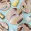 Example of round pinky beige cookies decorated with marbled brown, white, blue and gold Colourmill Edible Paint Blends