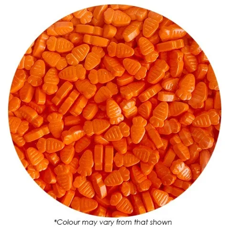 Close-up of orange candy shaped like carrots on a white background