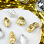 Gold and silver shell-shaped chocolates on a white surface with disco balls and tinsel in the background.