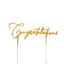 Gold 'Congratulations' cake topper on a white background