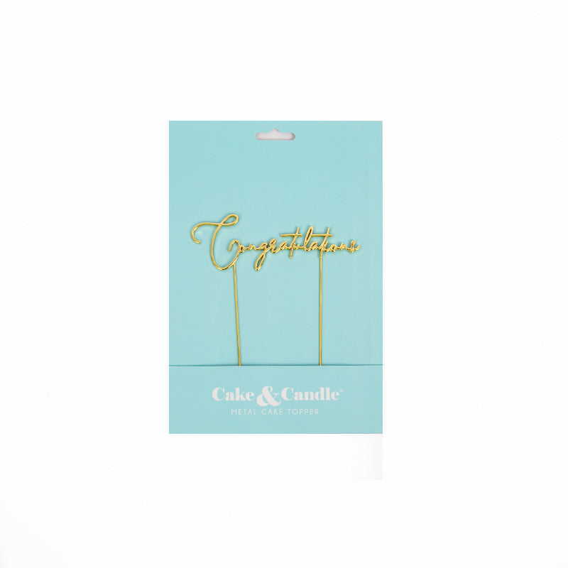 Gold 'Congratulations' cake topper set on a light blue card with 'Cake & Candle' branding.