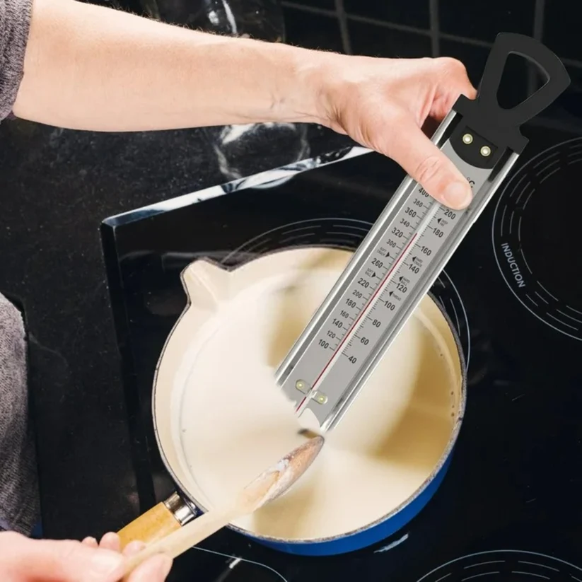 Wilton thermometer held in a pot of candy
