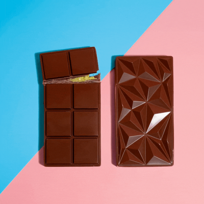 Chocolate bar with geometric design on a pink and blue background