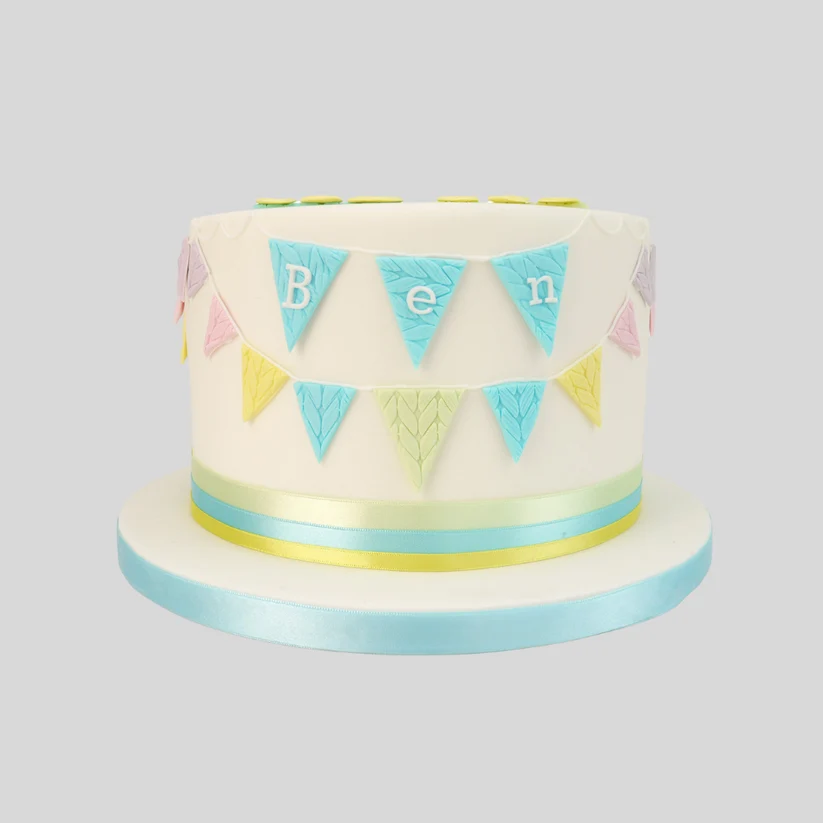 A pastel cake with Ben inside bunting flags