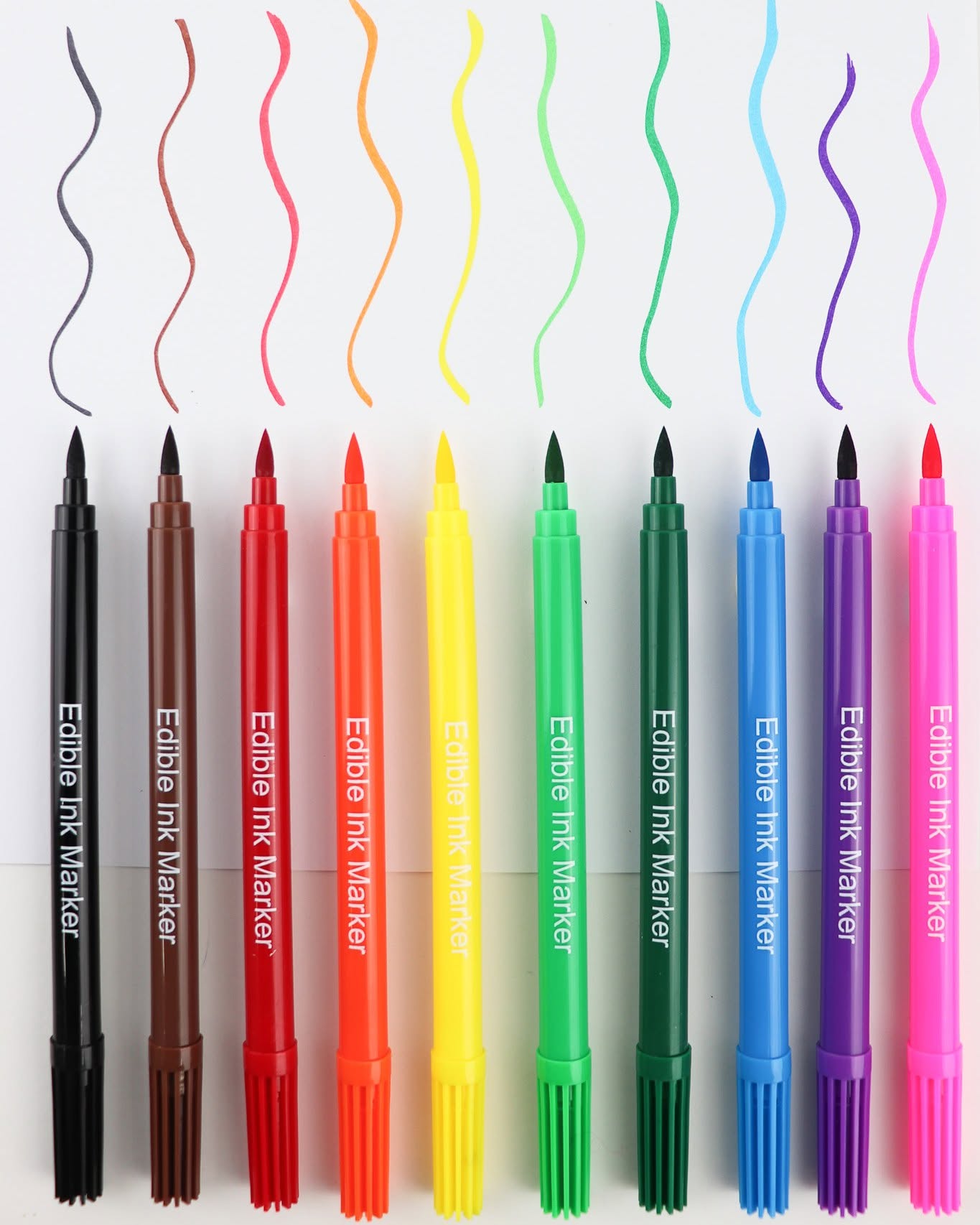 Ten dual-tip edible ink markers in assorted colors are lined up horizontally on a white background, each showing a wavy line of the corresponding marker color above it.