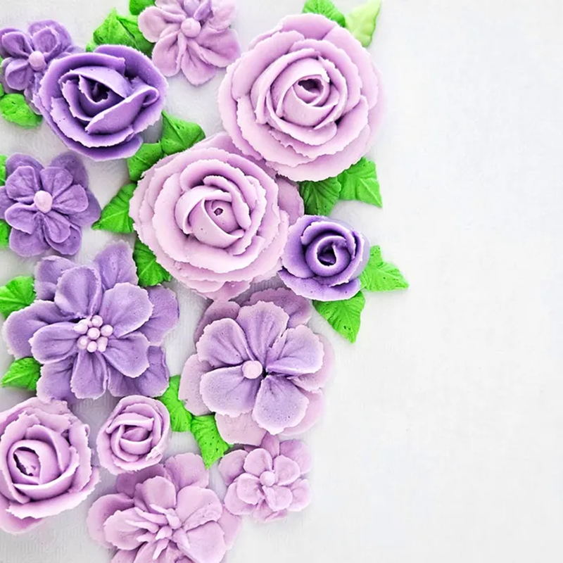 Examples of piped flowers created using the flower and leaf piping tip set