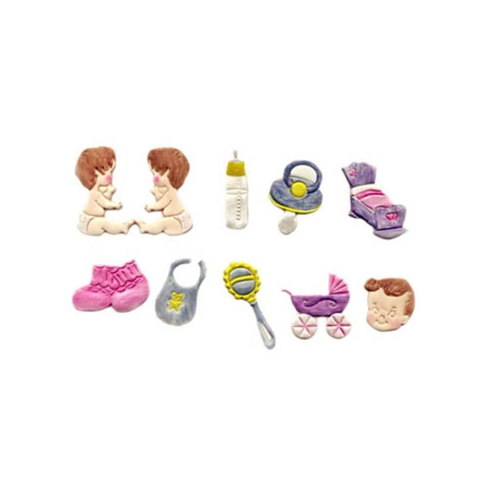 A set of small dollhouse or miniature baby-themed fondant cut outsarranged on a plain white background, including two seated figures, a bottle, pacifiers, a bed, shoes, a bib, a rattle, a stroller, and a small head piece.