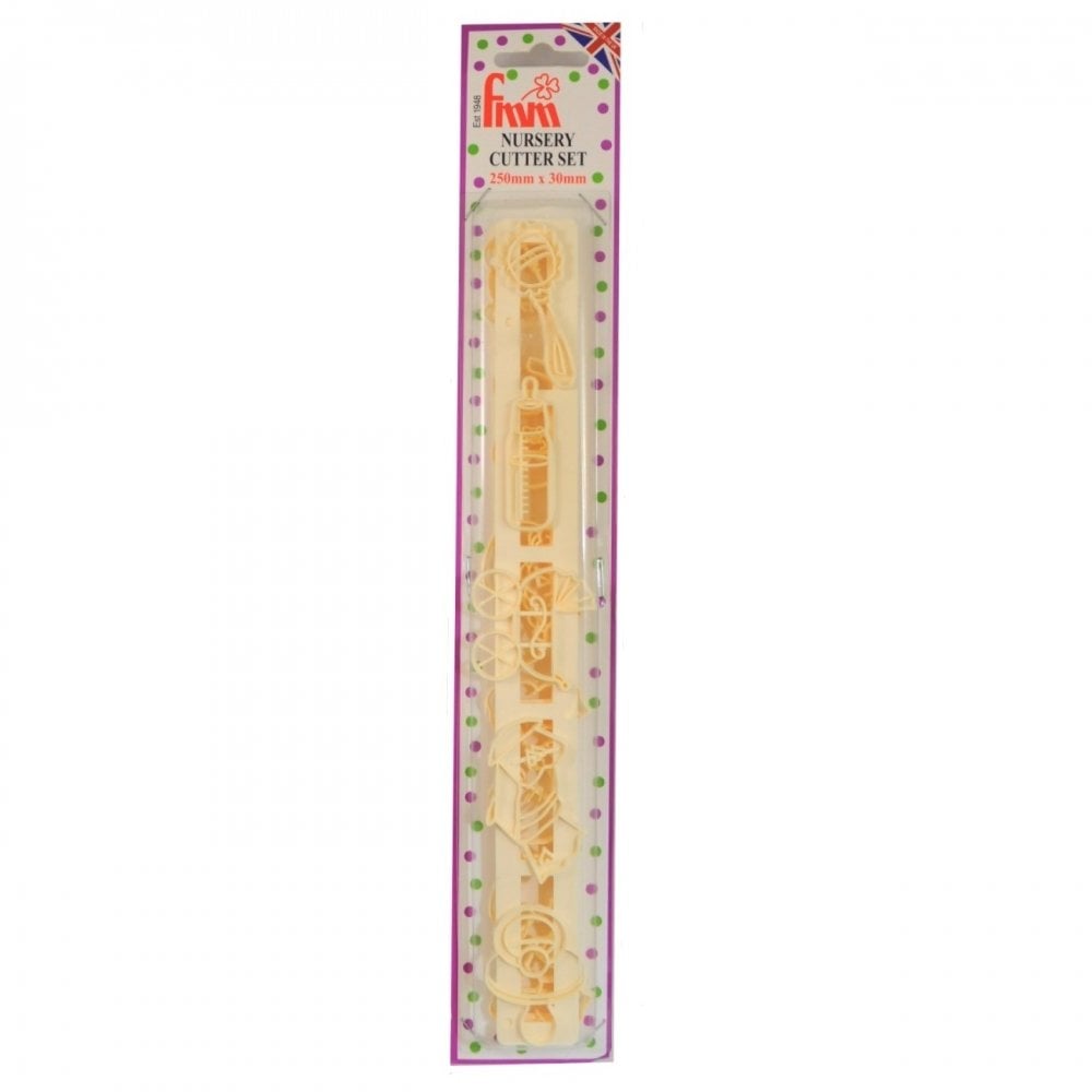 A packaged nursery cutter set containing 10 pieces, including a teapot, cup, spoon, bottle, and flower motifs. The set is packaged in a tall, narrow cardboard sleeve with a pink and green polka-dot border and a clear plastic window showing the pale yellow plastic cutters inside.