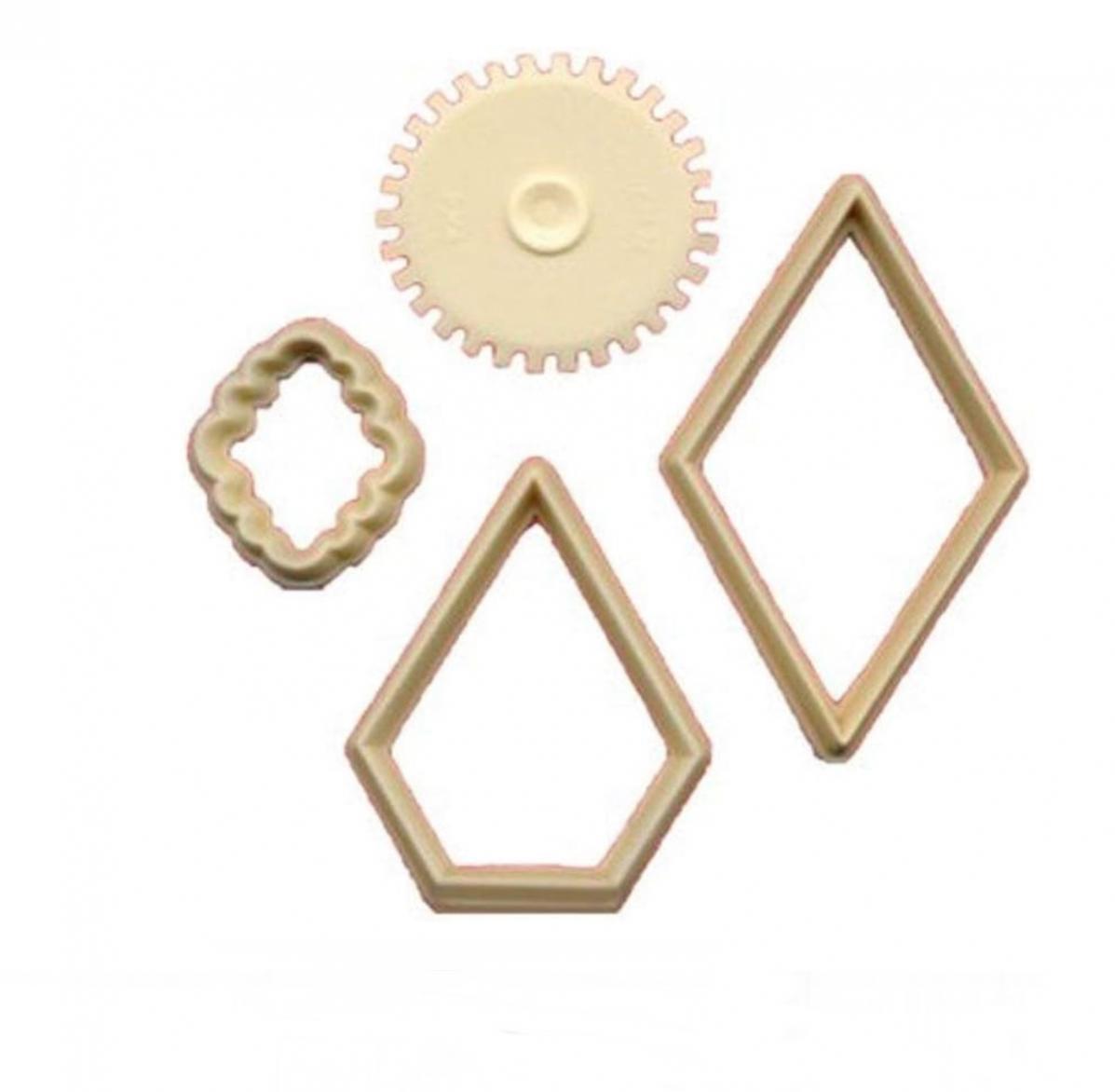 Four beige plastic fondant cutters including a stitching tool, a clover-shaped piece, and two diamond-shaped frames, arranged on a plain white background.