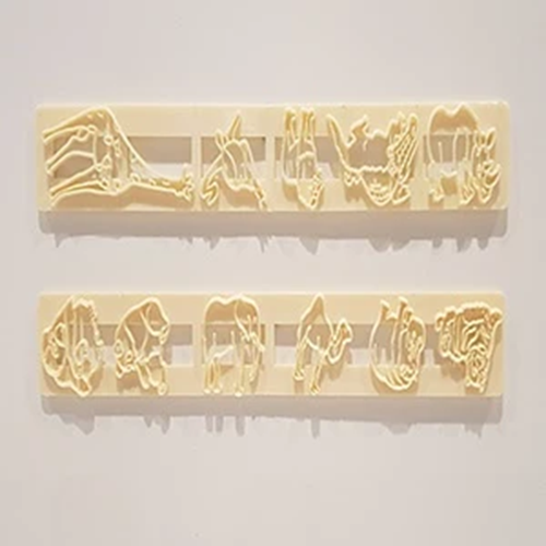 Two rectangular beige plastic cutters with embossed animal silhouettes, shown against a plain light background.