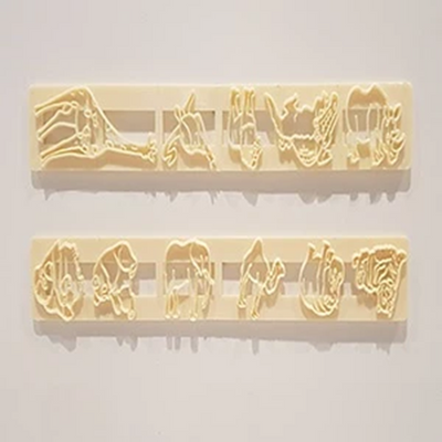 Two rectangular beige plastic cutters with embossed animal silhouettes, shown against a plain light background.