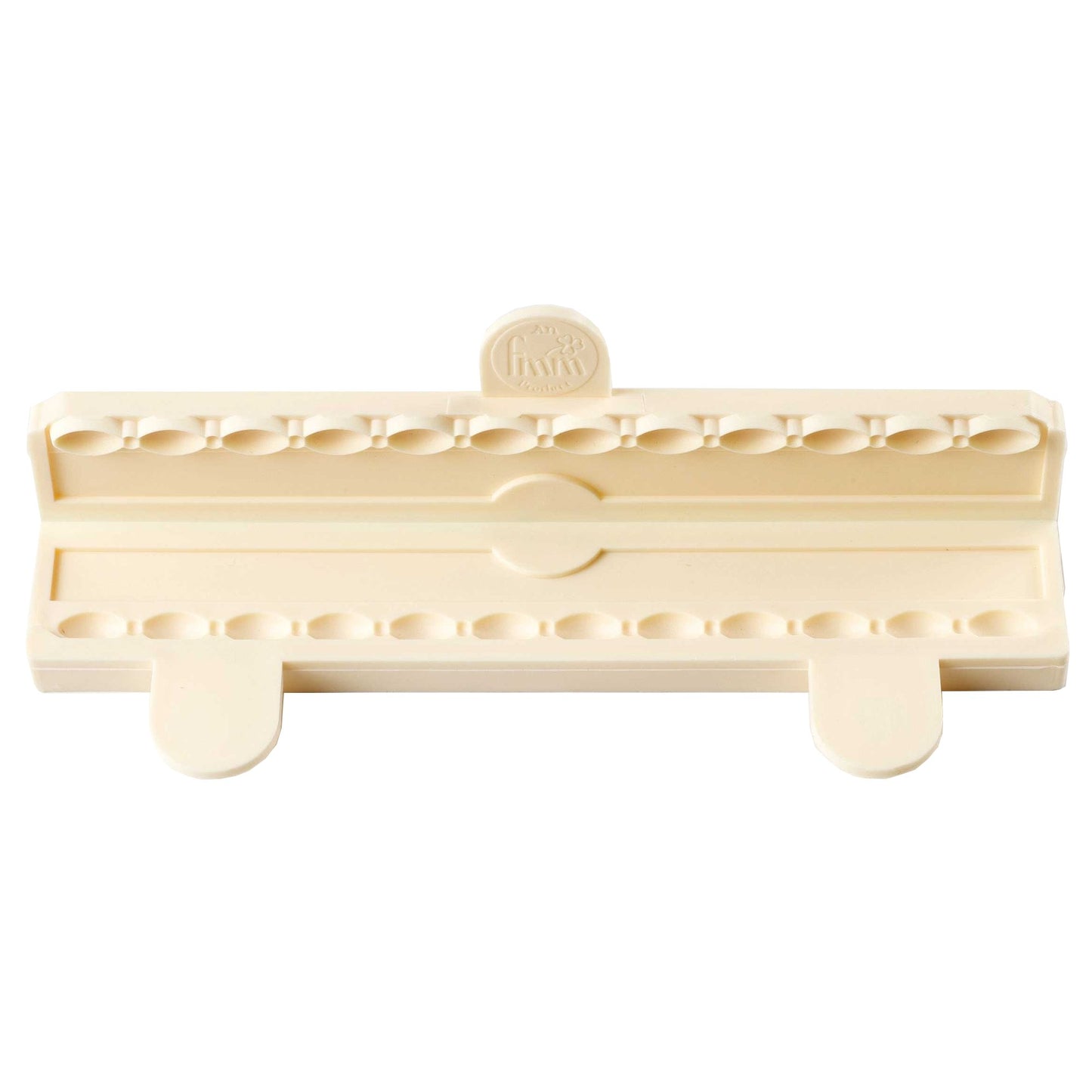 Beige plastic fondant tool with multiple holes on a white background