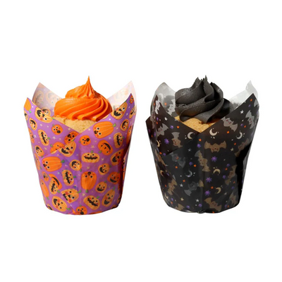 Two cupcakes in Halloween-themed wrappers on a white background