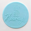 A round light blue fondant icing plaque with the words 'HIP HIP Hooray!' embossed in white, shown on a plain off-white background.