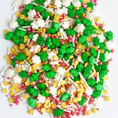 Assorted colorful Christmas-themed sprinkles on a white background