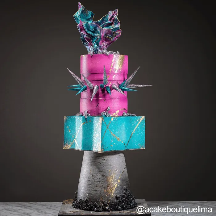 Elegant cake with pink and blue design on a dark background
