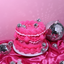 Pink cake with disco balls on a pink satin surface and pink background