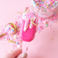 Pink ice cream bar with colorful sprinkles on a pink background