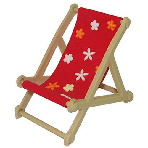 A miniature deck chair set with a red fabric seat printed with white and orange flowers, light wood frame made of fondant icing