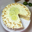 Cake with edge cut out decorated with sliced limes