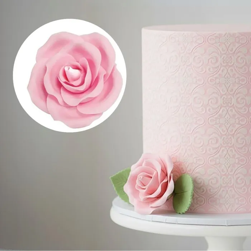 Pink cake with a decorative rose and close-up of the rose on a gray background