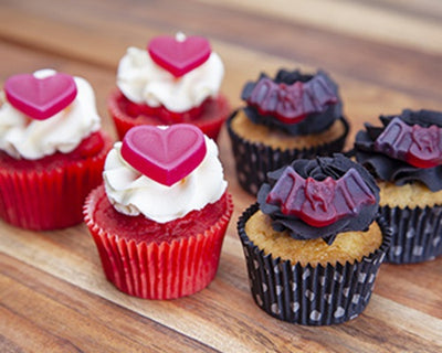 cupcakes with heart lolly and bat lollies topping them