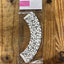 Music note patterned cupcake wrapper on a wooden surface with 'Cupcake Savvy' packaging.