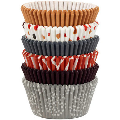 Stack of colorful cupcake liners with various patterns on a white background