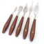 Set of five paint knives with brown handles and numbered labels on a white background