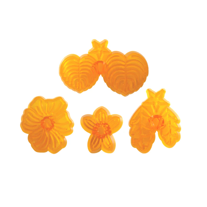 Set of four orange jem cutters shaped like  flowers for pansy and violet on a white background.