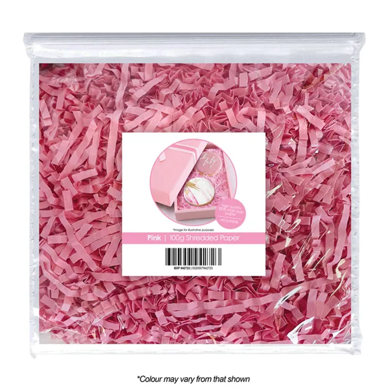 Pink shredded paper in a clear package with a label on a white background