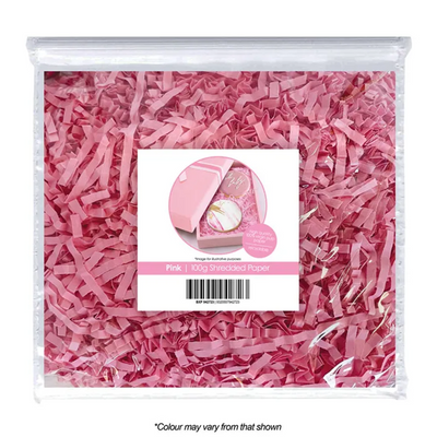 Pink shredded paper in a clear package with a label on a white background