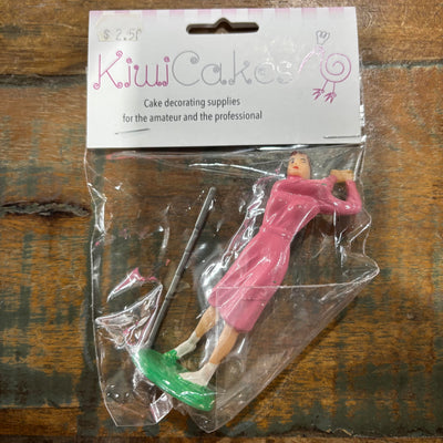 Golfing figure with pink dress