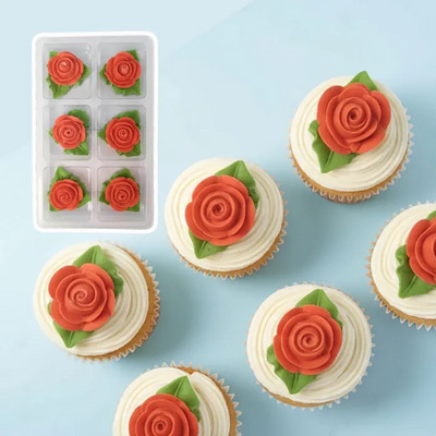 Cupcakes decorated with red icing roses on a blue background