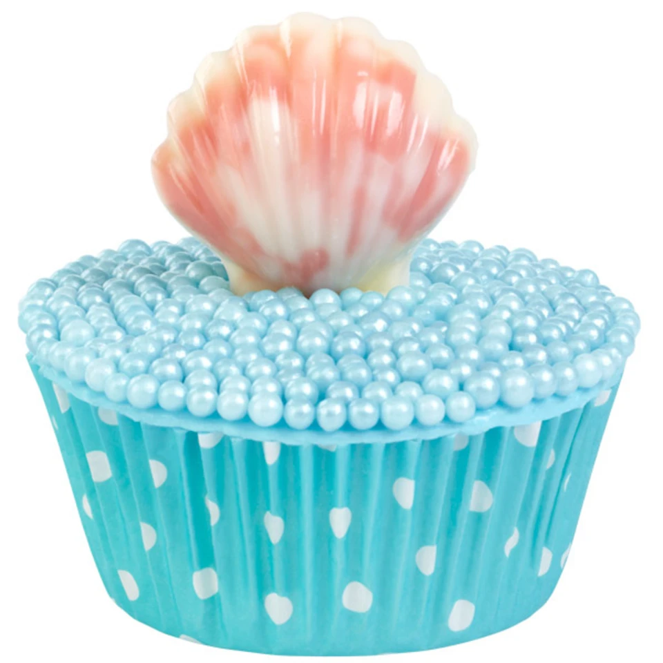 A decorative cupcake with a turquoise blue polka-dot wrapper, light blue pearl-like frosting, and a pink-and-white seashell topper on a plain white background.