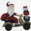 fondant icing decoration of Santa Claus on a scooter with a gift bag.