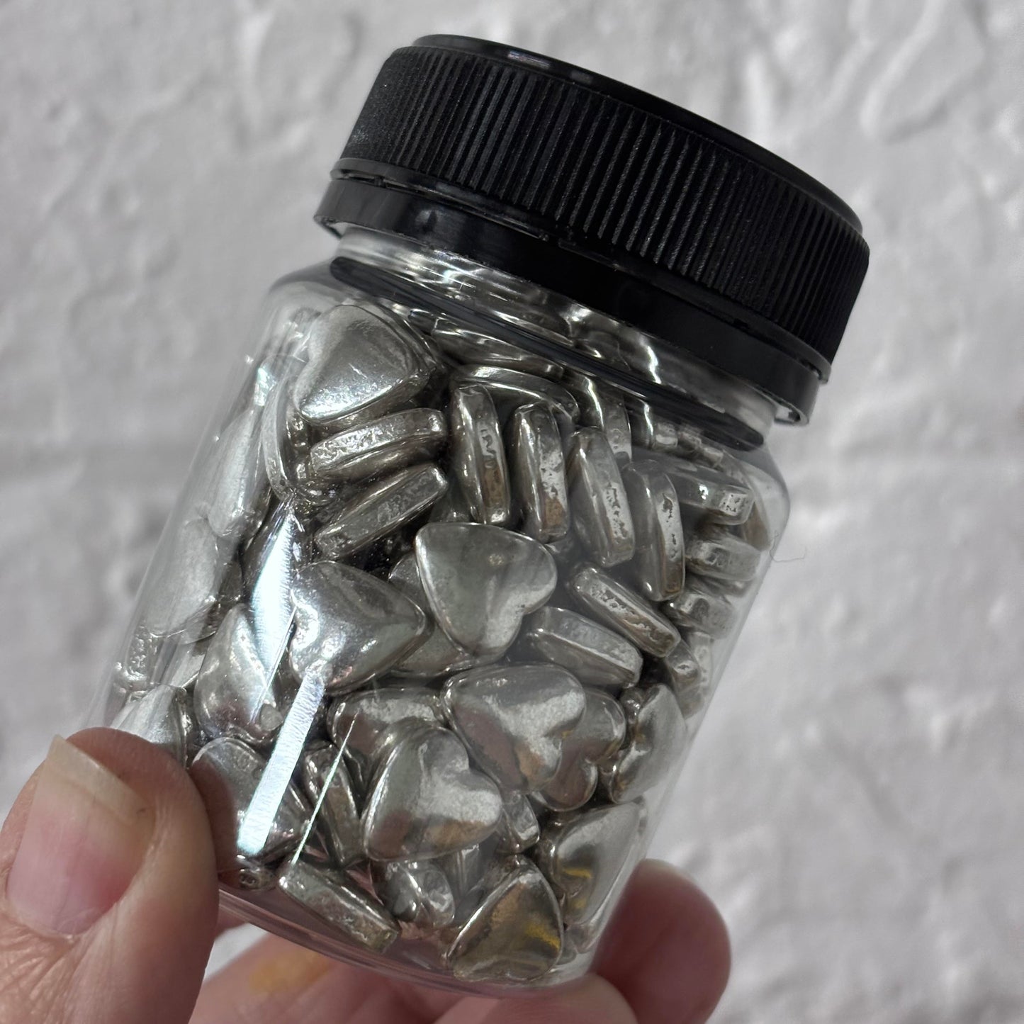 edible silver hearts dragees in jar
