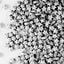 A pile of small metallic silver star-shaped sprinkles scattered across a plain white background.