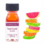 A bottle of Lorân Oils Tutti-Frutti Flavour essential oil next to a stack of colorful fruit slice gummy candies on a white background.
