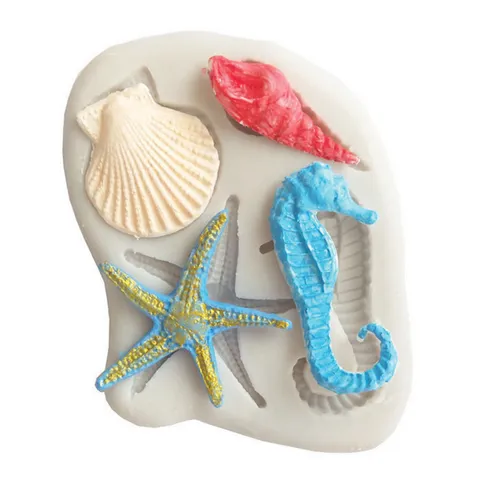 A silicone baking mould featuring sea-themed designs, including a blue seahorse, a yellow and blue starfish, a red spiral shell, and a beige scallop shell, shown on a white background.