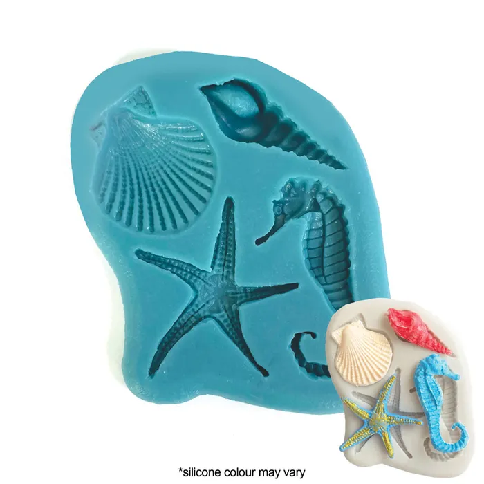 A blue silicone mould with embossed seashell, starfish, and seahorse shapes, shown alongside a small sample of molded sea-themed items on a white background. Text at the bottom reads '*silicone colour may vary'.